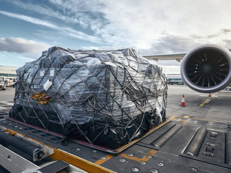 Preparation before flight. Loading of cargo container against airplane.